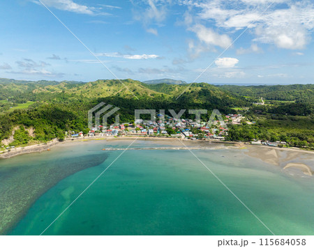 Residential aera and buildings in Santa Fe. Turquoise sea water at shoreline. Tablas, Romblon. Philippines. 115684058