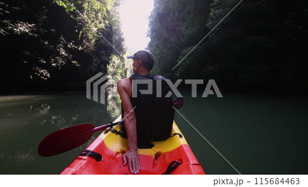 Tourist rests sitting on kayak admiring beauty of canyon 115684463