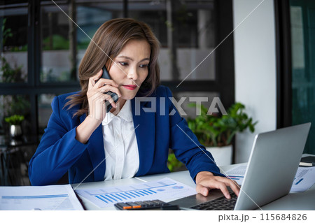 beautiful young business woman with laptop and phone beautiful young business woman with laptop and phone 115684826