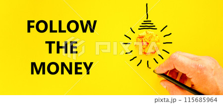 Follow the money symbol. Concept words Follow the money on beautiful yellow paper. Beautiful yellow background. Light bulb icon. Businessman hand. Business and follow the money concept. Copy space. 115685964