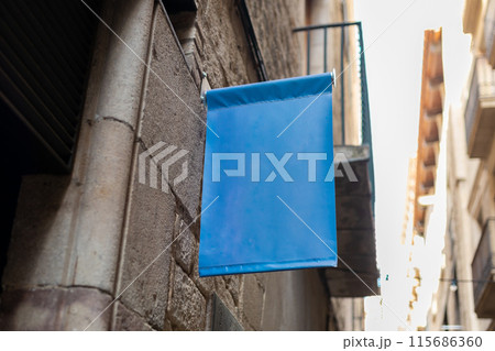 Blank sign mockup in the urban environment. Blue rectangle sign with blank space for cafe or restaurant name and logo, in an old town. 115686360