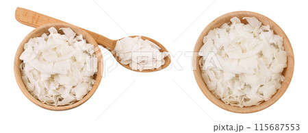 Coconut flakes or chips in wooden bowl isolated on white background. Top view. Flat lay Coconut flakes or chips in wooden bowl isolated on white background. Top view. Flat lay 115687553