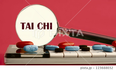 Sports and signal. Sign tai chi through a magnifying glass on a calculator with pills on it on a red background with a white spot from a magnifying glass 115688032