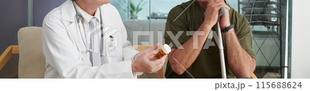 Doctor Prescribing Pills To Patient 115688624
