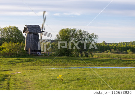 Rural Russian landscape with an old wooden windmill on the coast of Sorot river Rural Russian landscape with an old wooden windmill on the coast of Sorot river 115688926