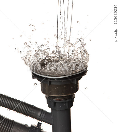 Pouring Leaking water from gray plastic pipe drain sink. Drain sink leak water from pipe plumbing in bathroom as water splash clogged drop. White background isolated Pouring Leaking water from gray plastic pipe drain sink. Drain sink leak water from pipe plumbing in bathroom as water splash clogged drop. White background isolated 115689234