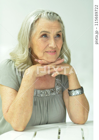 Portrait of happy senior woman posing at home Portrait of happy senior woman posing at home 115689722