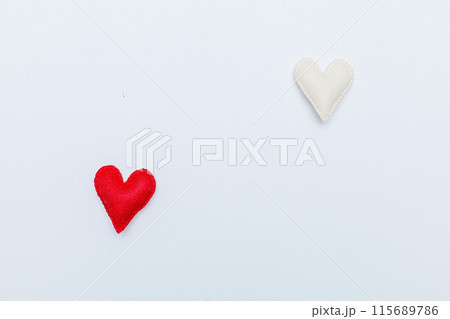 Red felt valentine heart hanging from a rope fixed by wooden clothespin isolated on white background 115689786