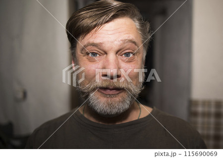 A man with facial hair is smiling in a quirky portrait A man with facial hair is smiling in a quirky portrait 115690069