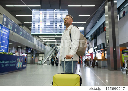 Young Caucasian male passenger in stylish casual clothes using smartphone and laptop keyboard, sit has training online meeting on laptop computer in airline lounge wait transit international airport Young Caucasian male passenger in stylish casual clothes using smartphone and laptop keyboard, sit has training online meeting on laptop computer in airline lounge wait transit international airport 115690947