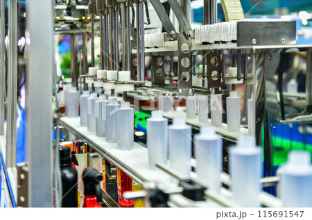 White plastic bottles in a conveyor belt on a high quality automatic vertical filling machine. in the factory production line 115691547