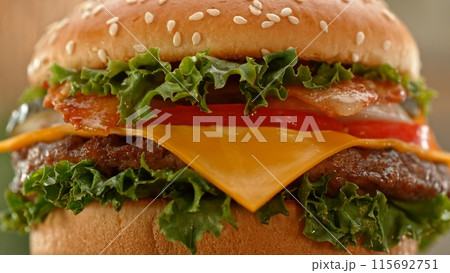 Close-up of home made tasty burgers on old olive wooden table. 115692751