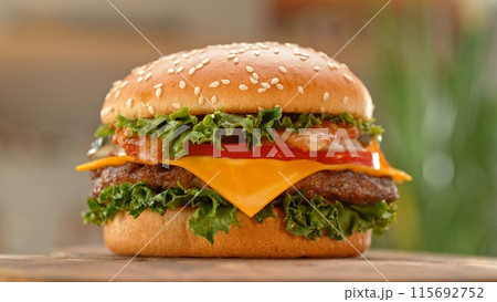 Close-up of home made tasty burgers on old olive wooden table. Close-up of home made tasty burgers on old olive wooden table. 115692752