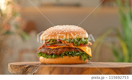 Close-up of home made tasty burgers on old olive wooden table. Close-up of home made tasty burgers on old olive wooden table. 115692753
