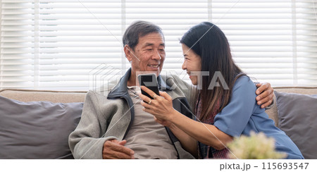 Elderly Couple Enjoying Modern Technology Together, Engaging in Phone Shopping and Social Media Interaction 115693547