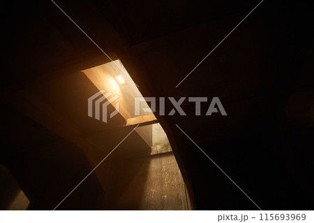 Dark concrete room with warm light 115693969