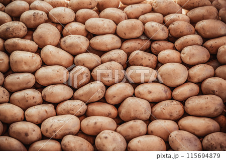 Closeup of Brown Potatoes in a Market Stall 115694879