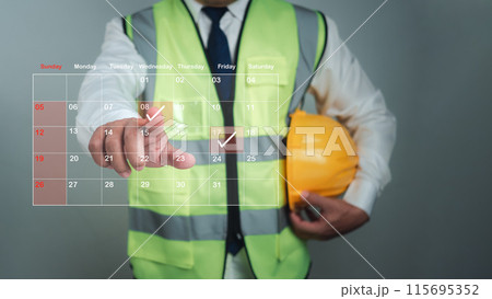 Architect or engineer Pointing finger at construction marking dates on virtual calendar, Project presentation plan, Construction cost planning, Construction planning, Appointment scheduler. Architect or engineer Pointing finger at construction marking dates on virtual calendar, Project presentation plan, Construction cost planning, Construction planning, Appointment scheduler. 115695352