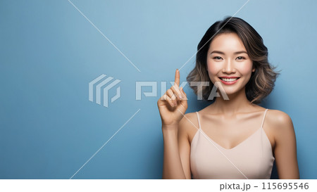 Horizontal shot, pleased japanese woman, points away with forefinger, shows blank space for your promotion, isolated over blue background. People, advertisement concept. Generated AI Horizontal shot, pleased japanese woman, points away with forefinger, shows blank space for your promotion, isolated over blue background. People, advertisement concept. Generated AI 115695546