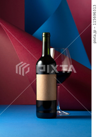 Bottle and glass of red wine. 115696313