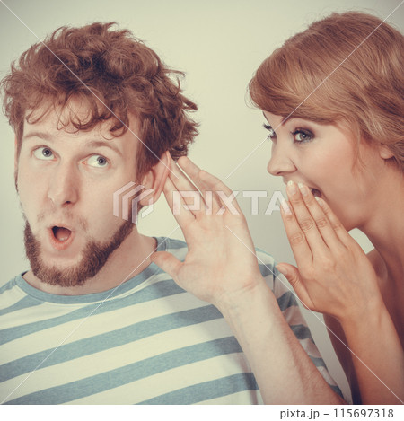 Woman telling an astonished man some secrets Woman telling an astonished man some secrets 115697318