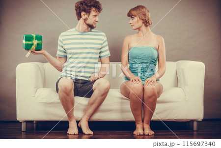 Young man giving woman gift box 115697340