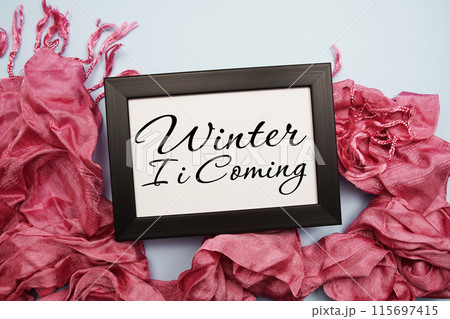 Winter is Coming text message with pink scarft on blue background Winter is Coming text message with pink scarft on blue background 115697415