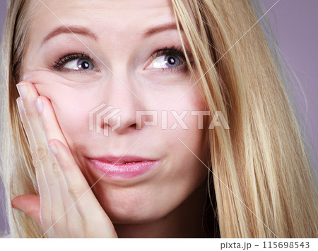 Young teenager woman thinking with hand on cheek 115698543