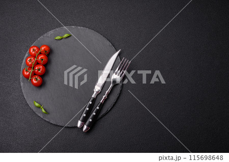 Empty round slate plate for template on the black background Empty round slate plate for template on the black background 115698648