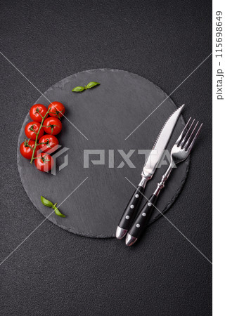 Empty round slate plate for template on the black background Empty round slate plate for template on the black background 115698649