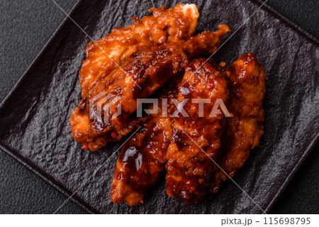 Delicious chicken fillet sliced and baked with teriyaki sauce 115698795