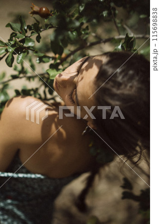 Stylish woman in nature with a snail, under daylight, evoking peace and harmony Stylish woman in nature with a snail, under daylight, evoking peace and harmony 115698838