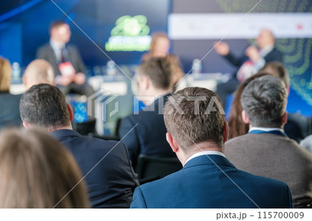 Audience attentively listening to speakers at a business conference 115700009