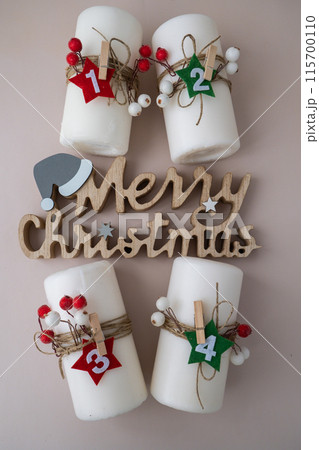 Merry Christmas wooden message New year and Christmas preparation. Four-week advent candles on table. Handmade eco-friendly decor. Sustainable Christmas decoration Merry Christmas wooden message New year and Christmas preparation. Four-week advent candles on table. Handmade eco-friendly decor. Sustainable Christmas decoration 115700110