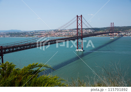 Famous Abril bridge in Lisbon, crossing the Tagus River 115701892