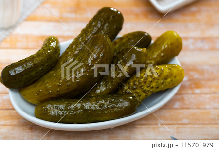 Pile of pickled cucumbers served on table 115701979