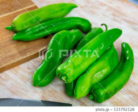 Green peppers on wooden table, cooking ingredients Green peppers on wooden table, cooking ingredients 115702126