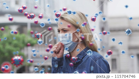 Image of virus cells over caucasian female wearing face mask coughing 115704746