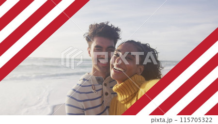 Image of flag of united states of america over biracial couple kissing by sea Image of flag of united states of america over biracial couple kissing by sea 115705322