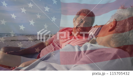 Image of flag of united states of america over senior biracial couple in deckchairs on beach Image of flag of united states of america over senior biracial couple in deckchairs on beach 115705432