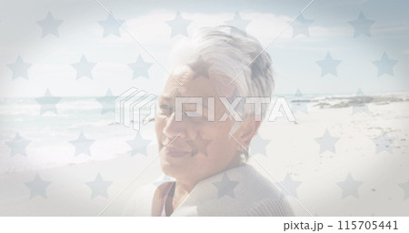 Image of flag of united states of america over smiling senior biracial woman on beach Image of flag of united states of america over smiling senior biracial woman on beach 115705441