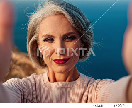 Mature woman taking selfie of video call 115705792
