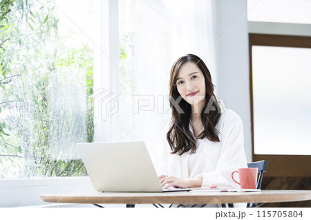 カフェでテレワークをする若い女性 115705804