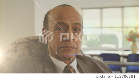 Image of glowing light over serious senior man at home 115706281
