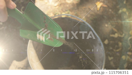 Image of blue lights over person working in the garden 115706351