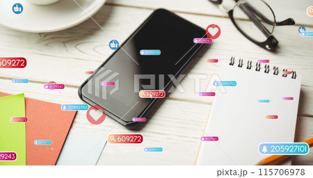 Image of social media like and love icons over smartphone on desk background 115706978
