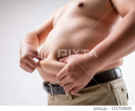 メタボリックシンドロームの男性がお腹の贅肉をつまむ,Generative AI AI画像 115709680
