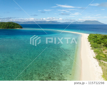 Bon Bon Beach with transparent sea water and waves. Blue sky and clouds. Romblon Island. Romblon, Philippines. Bon Bon Beach with transparent sea water and waves. Blue sky and clouds. Romblon Island. Romblon, Philippines. 115712298
