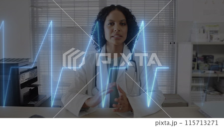 Image of cardiograph over happy biracial female doctor having image call 115713271