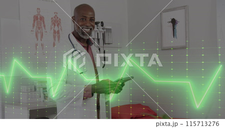 Image of cardiograph over happy african american male doctor with tablet 115713276